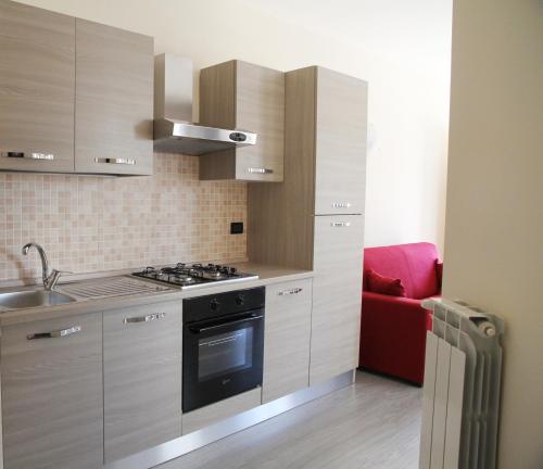 特尔尼Appartamenti Il Cerqueto 2的厨房配有水槽和炉灶 顶部烤箱