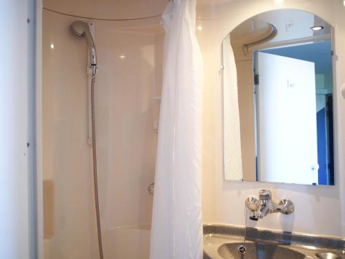 尼奥尔普瑞米尔尼奥特伊斯特夏雷经典酒店的带淋浴、水槽和镜子的浴室
