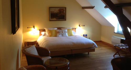 迪尔贝克昂斯姆豪弗旅馆的一间卧室配有一张大床和一把椅子