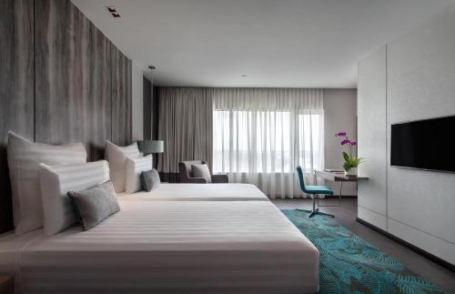 米里普尔曼美里海滨酒店的酒店客房设有两张床和电视。