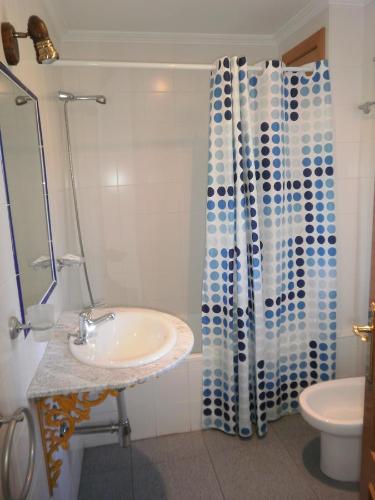 夸科斯德尤斯特Hostal Miraflor de las Cadenas的一间带水槽和淋浴帘的浴室