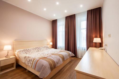 圣彼得堡伊格尔克宾馆的一间卧室设有一张床和两个窗户。