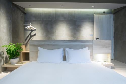 鱼池乡勺光-188的卧室配有一张带两个枕头的大白色床