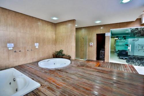 桑托斯蒙特塞拉酒店的大型浴室设有两个盥洗盆和浴缸。