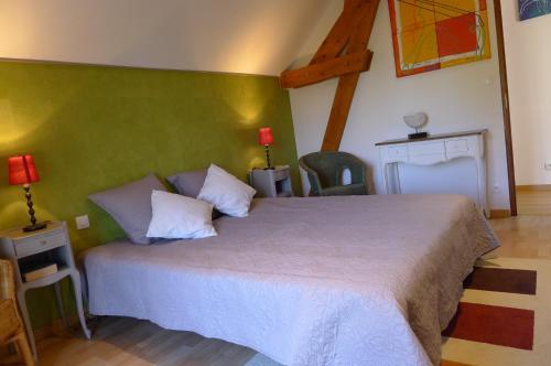 CiranChambre d'hote Le sablonnet的一间卧室设有一张大床和绿色的墙壁