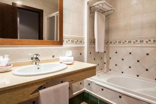 代米耶尔曼努埃拉夫人酒店的一间带水槽和浴缸的浴室