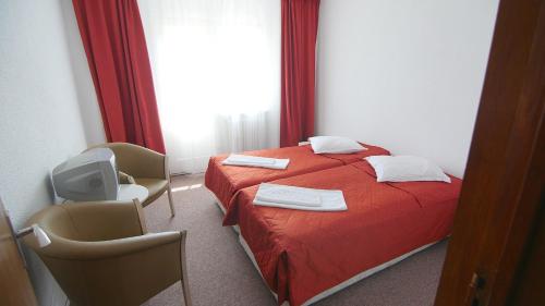 CumpănaCabana Cumpana的酒店客房配有红色的床和两把椅子
