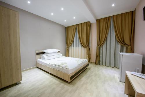 尼普顿Vila Puky的一间卧室设有一张床和两个窗户。
