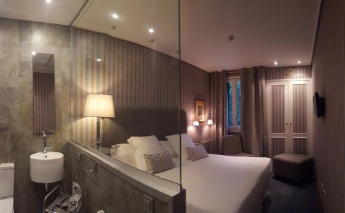 苏马拉加艾克斯百里酒店的酒店客房,配有床和镜子