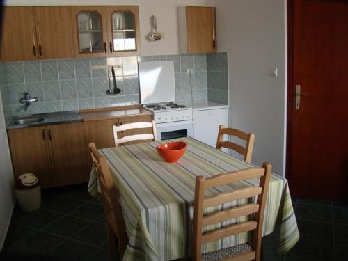 布德瓦Apartments Svorcan的厨房配有桌子和碗