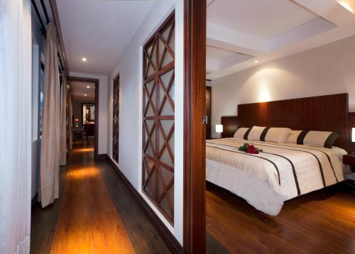 昆卡格兰哥伦比亚套房公寓的一间卧室设有一张大床和一个走廊