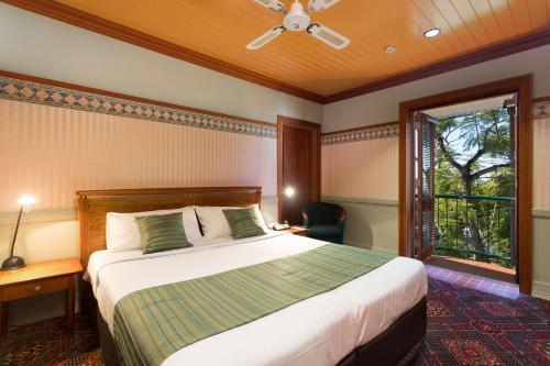 布里斯班曼利宾馆的一间卧室设有一张大床和一个窗户。