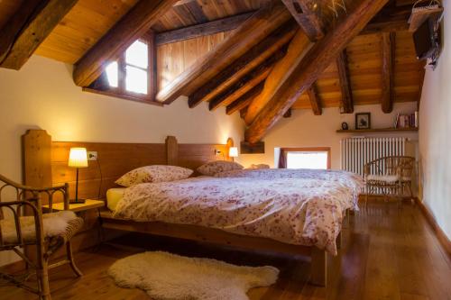 阿兰尼亚·瓦尔塞西娅自由的三棵树酒店的一间卧室设有床、窗户和木制天花板