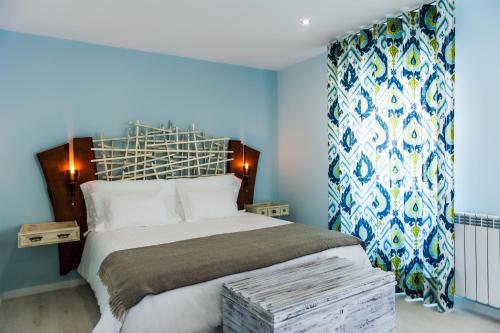 塞亚Casa da Ribeira do Círio的一间卧室配有一张带蓝色墙壁的大床