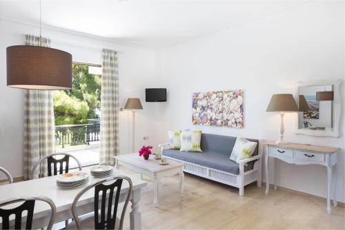 莫奈姆瓦夏Douka Sea Front Residencies的客厅配有蓝色的沙发和桌子