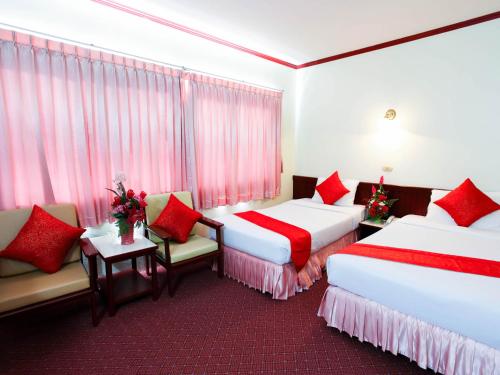 春蓬春蓬皇宫酒店的红色点缀的酒店客房内的两张床