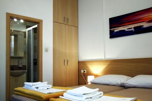 奥西耶克Rooms Fitea的一间卧室配有两张床和白色毛巾。