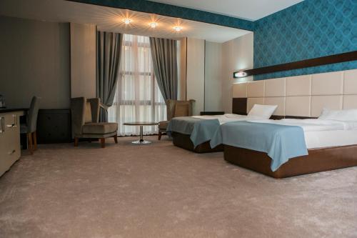 巴库Azalea Hotel Baku的酒店客房设有两张床和蓝色的墙壁。