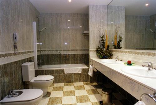 哈罗哈罗城市酒店的浴室配有卫生间、盥洗盆和浴缸。