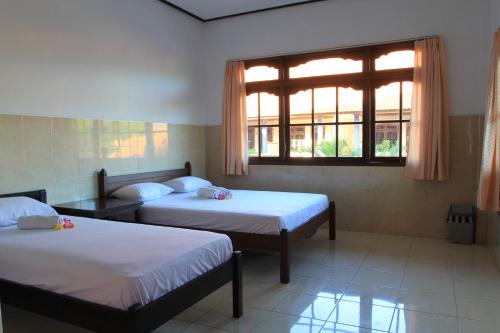 库塔杰帕卡3旅馆的客房设有两张床和窗户。
