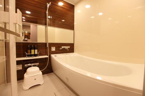 东京HOTEL AMANEK Ginza East的带浴缸、卫生间和盥洗盆的浴室