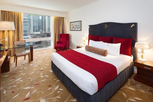 布里斯班皇家公园饭店的酒店客房设有一张大床和一张书桌。