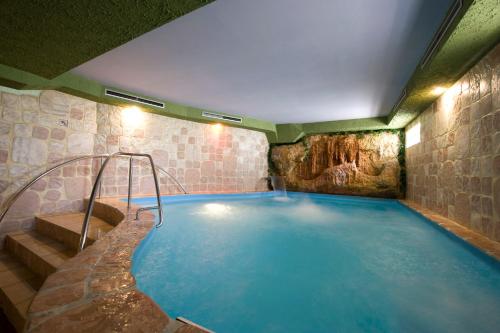 沙莫林科尔莫兰酒店的一座石头建筑中的大型游泳池