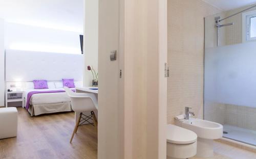 阿利坎特阿利坎特阿巴西亚酒店的一间带水槽和卫生间的浴室以及一张床