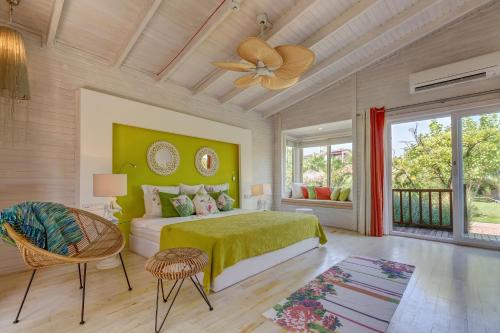 契拉勒卢卡别墅酒店的一间卧室配有绿色的床和吊扇