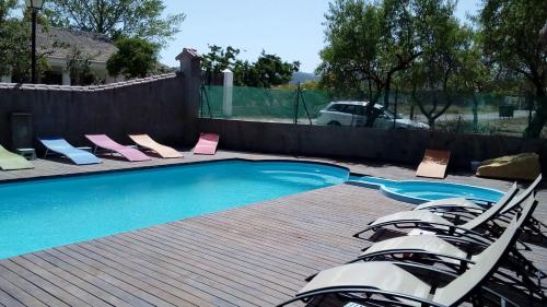 El ToroHotel Rural Los Abriles的围栏旁带躺椅的游泳池