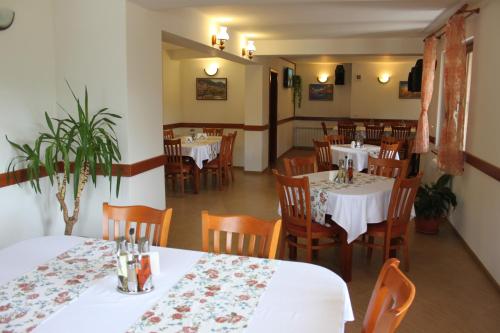 代温克里斯旅馆 的用餐室配有白色的桌子和木椅