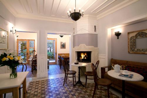 伊斯坦布尔佐伊女皇酒店 的客厅设有壁炉、桌子和椅子