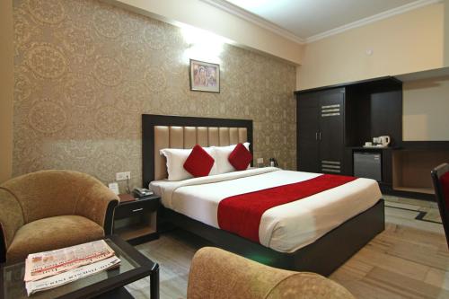 哈里瓦乐格兰酒店的酒店客房,配有一张床和两把椅子