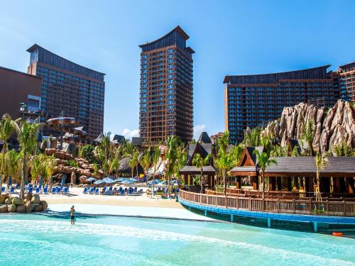 三亚三亚湾红树林度假世界-棕榈王国酒店的拥有海滩和高楼的一个度假胜地