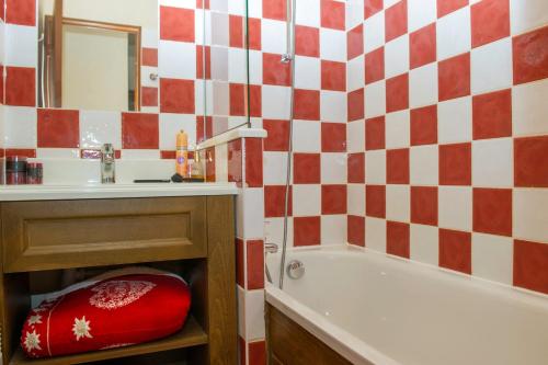 瓦卢瓦尔Résidence Goélia Les Chalets Valoria的浴室设有红色和白色的格子墙
