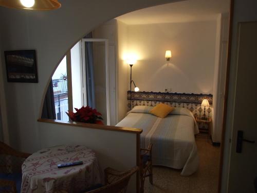锡切斯Apartamentos Montserrat的一间卧室配有一张床、镜子和窗户