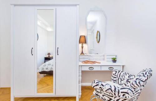 杜布罗夫尼克Apartment Majestic的一间卧室配有镜子和桌椅