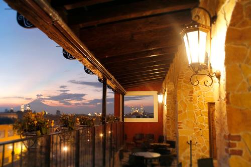 普埃布拉玛丽亚卡索纳酒店的阳台一侧有灯的建筑
