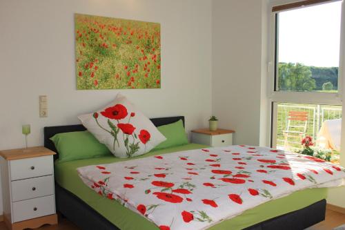 GrunaFährhaus Gruna的一间卧室配有一张带红色罂粟花被的床