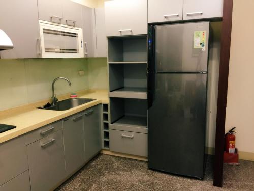 埔里恋上轻井泽民宿的厨房配有黑色冰箱和水槽