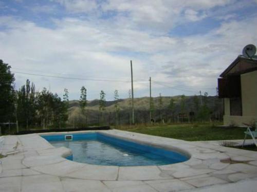 波特雷里约斯Casa Montaña Valle del Sol的一座小游泳池,位于带房子的庭院内