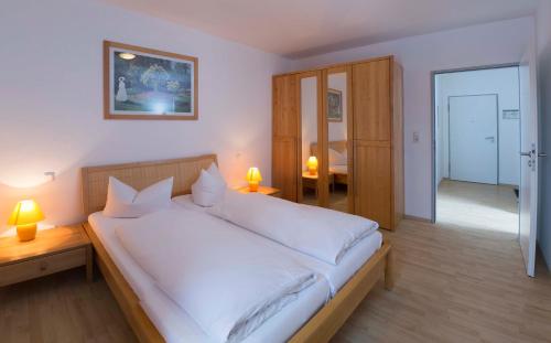 施尔奇Brockenblick Ferienpark的一间卧室配有一张带白色床单的大床