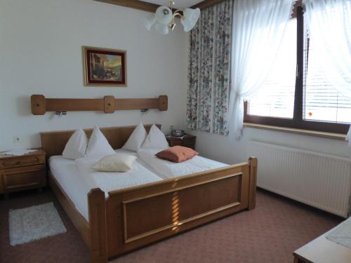 克查赫莱雷尔酒店的一间卧室配有一张带白色床单的床和一扇窗户。