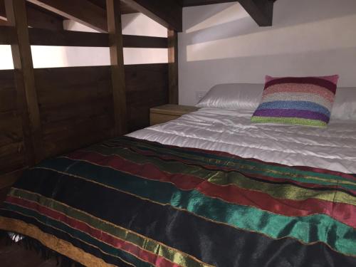 比利亚罗夫莱多Casa del Fraile的床上有五颜六色的毯子