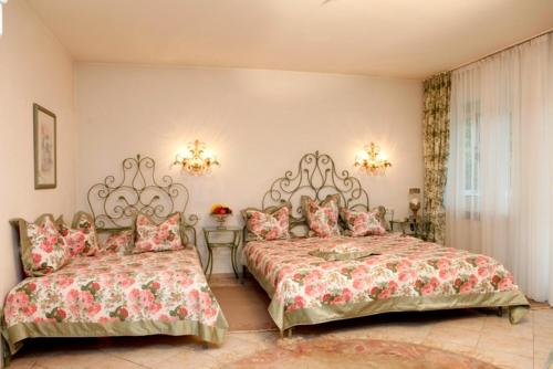 慕尼黑赛贝尔公园酒店的一间卧室设有两张床、两张桌子和窗户。