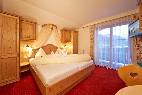 莱奥冈格伦沃尔德美食酒店的一间卧室设有一张床和一个大窗户