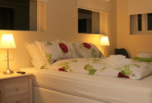 Vatnsholt1A旅馆的一张铺有白色床单和红色鲜花的床