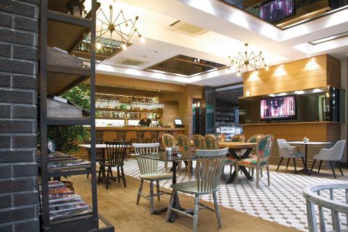 代尼兹利卡萨边卡酒店的一间带桌椅的餐厅和一间酒吧