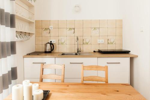 索波特Fiszer 1 & 2的厨房配有水槽和桌椅