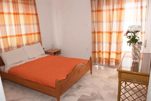 特里卡拉Meteora Christian's Place的一间卧室配有床和花瓶